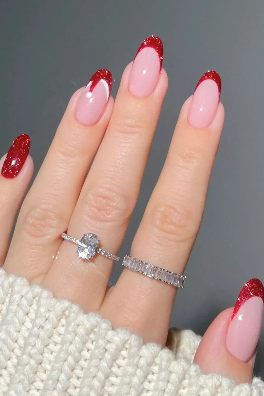 Abstract Red Glitter Drip Tips - Nude nails with unstructured red glitter tips resembling melting drips or hats.