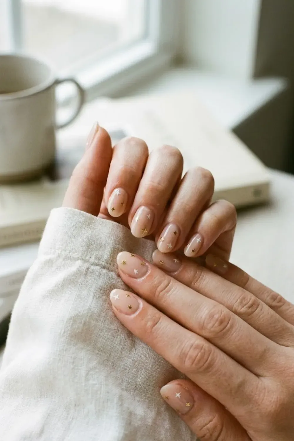 nude-nails-star-stickers. - Short nude nails with small star nail stickers, minimal and playful manicure.