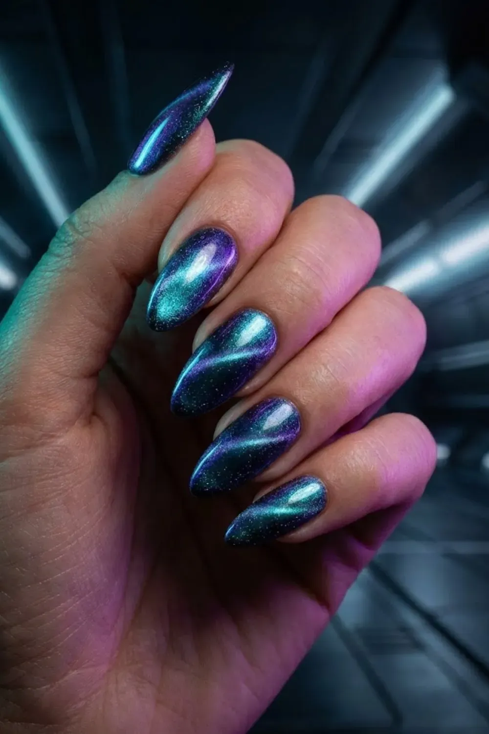 Multichrome cat eye nails shifting between teal blue and purple tones