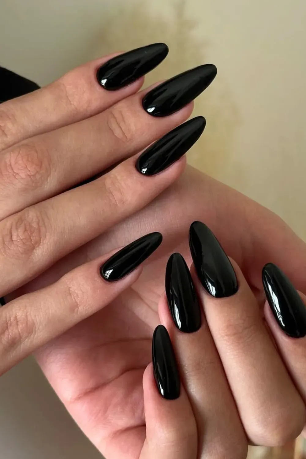 Classic Glossy Black Almond	Long almond shape nails painted solid glossy black