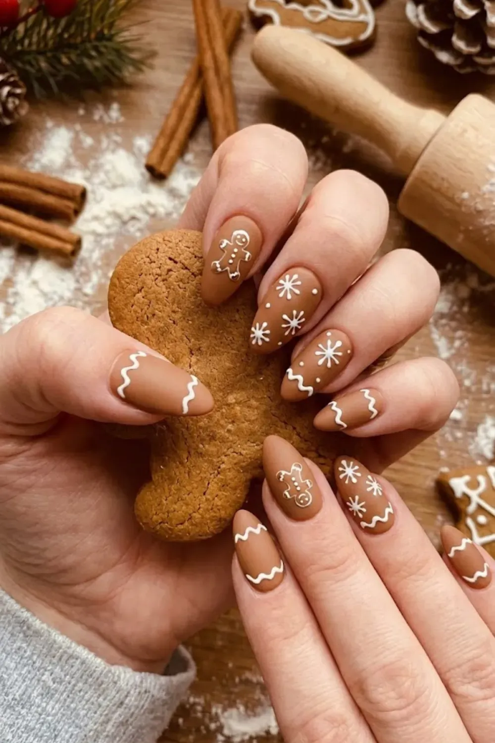 Matte Gingerbread Cookie Nail Design - Matte brown nails designed to look like gingerbread cookies with white icing details.