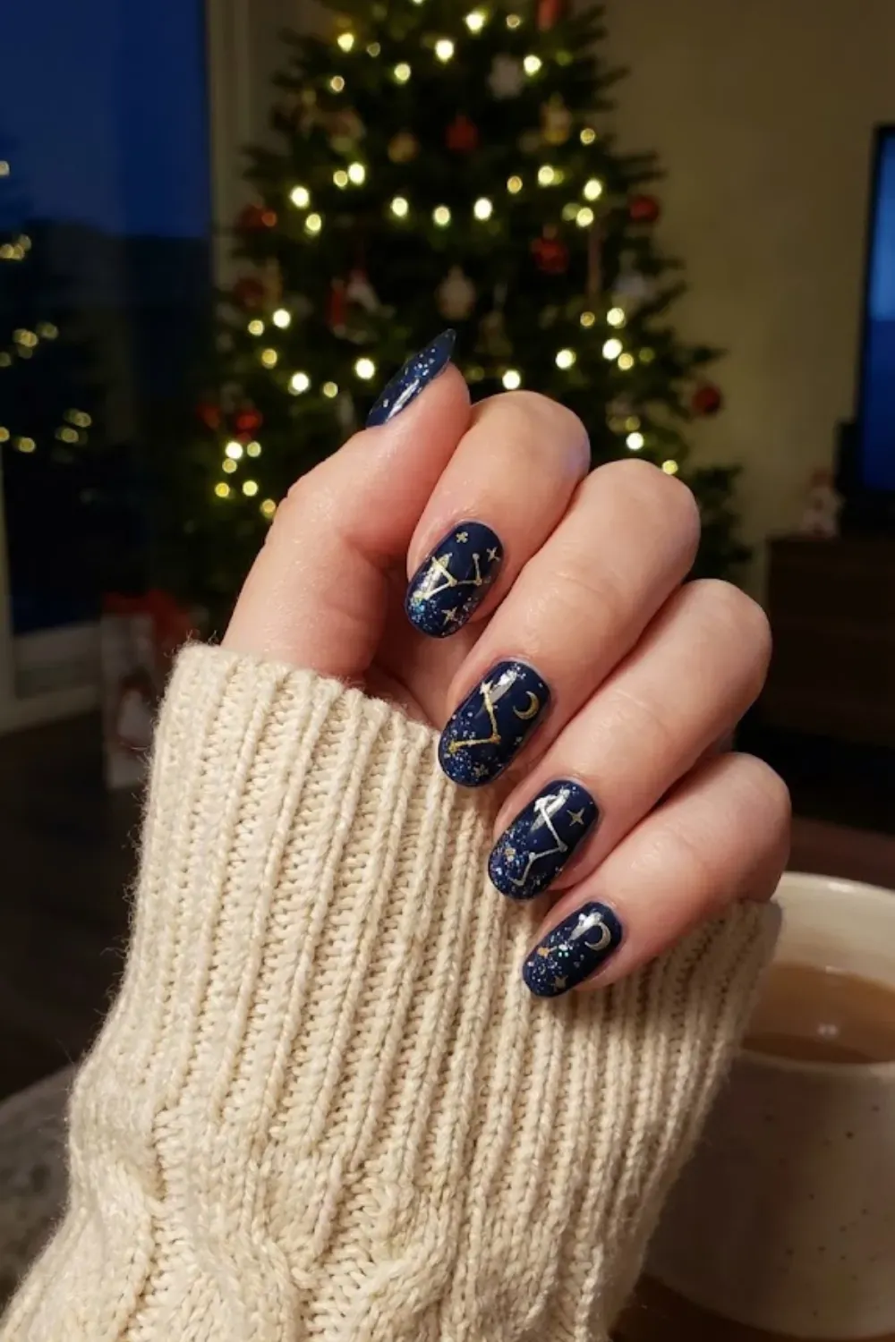 Navy and Gold Constellations - oval dark navy nails with delicate gold constellation lines and moon art