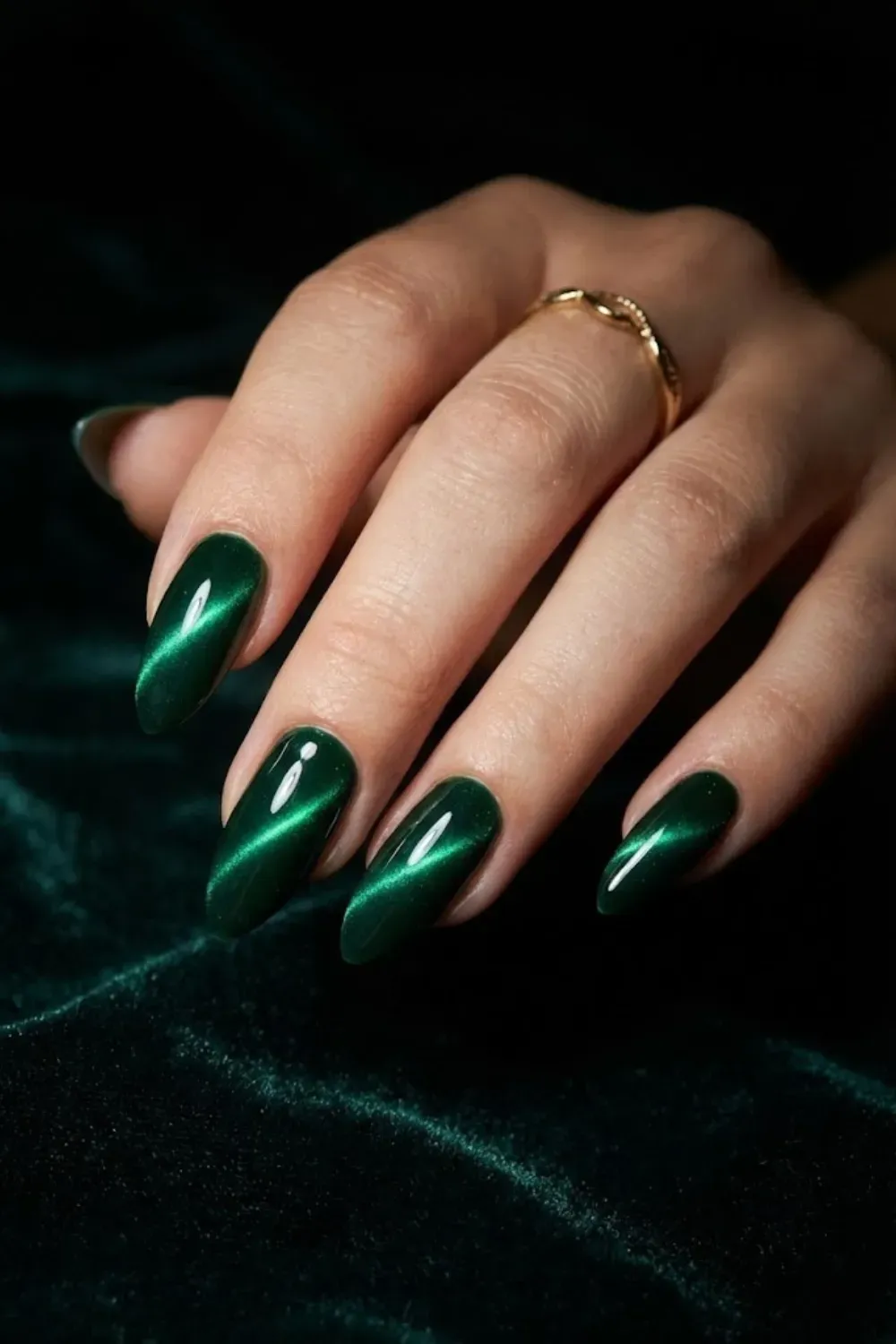 Forest green cat eye nails with bold glowing magnetic stripe