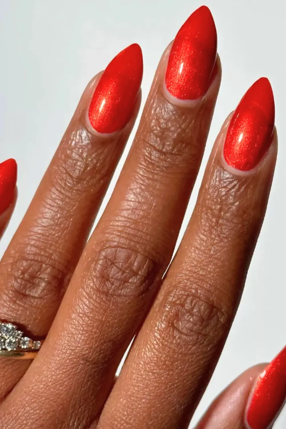 Classic Bright Red Shimmer Nails - Simple and elegant almond nails in a bright, shimmery red polish.