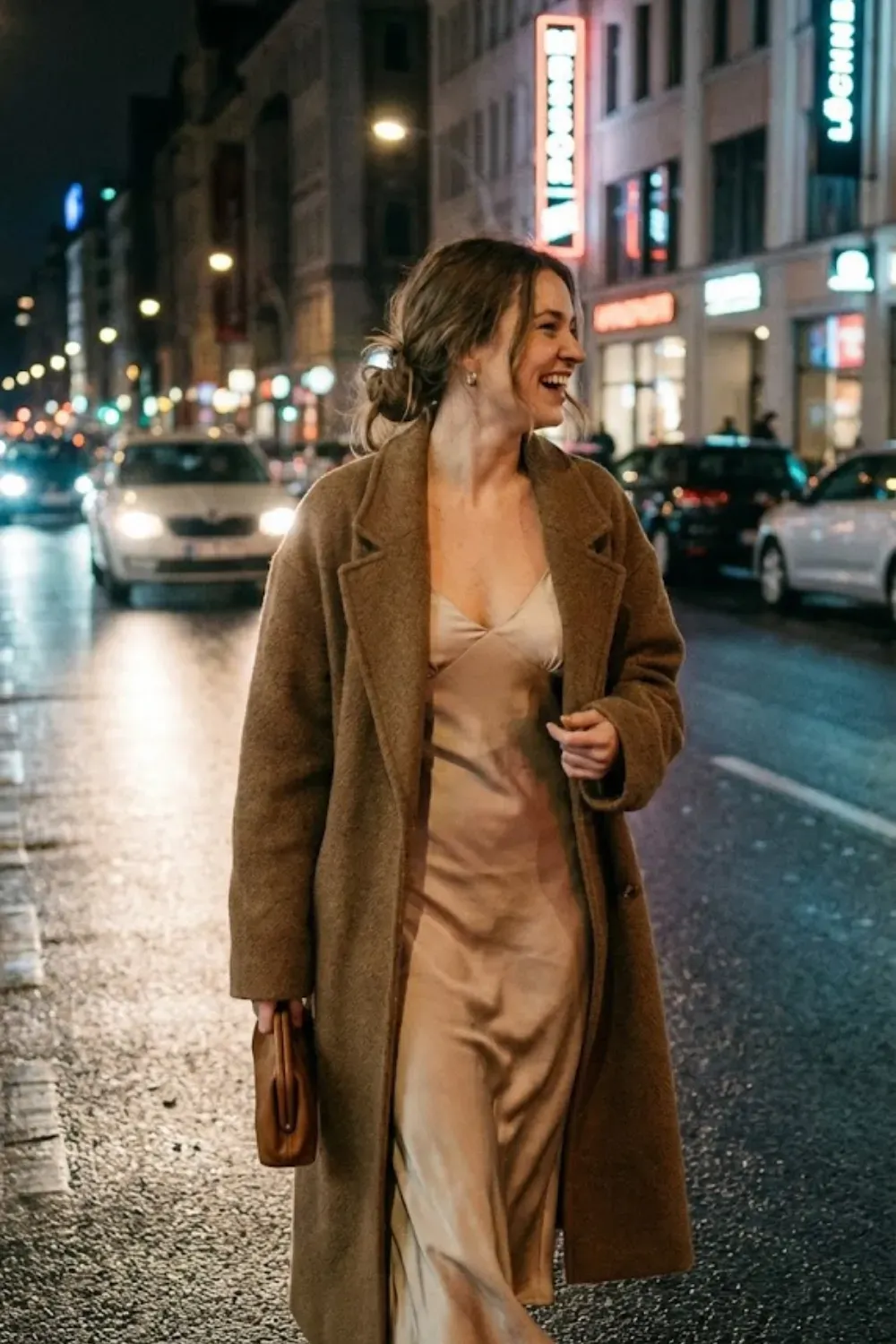 Silk Slip Dress & Oversized Coat – Evening look with a champagne silk slip dress layered under a dark brown textured coat in the city.