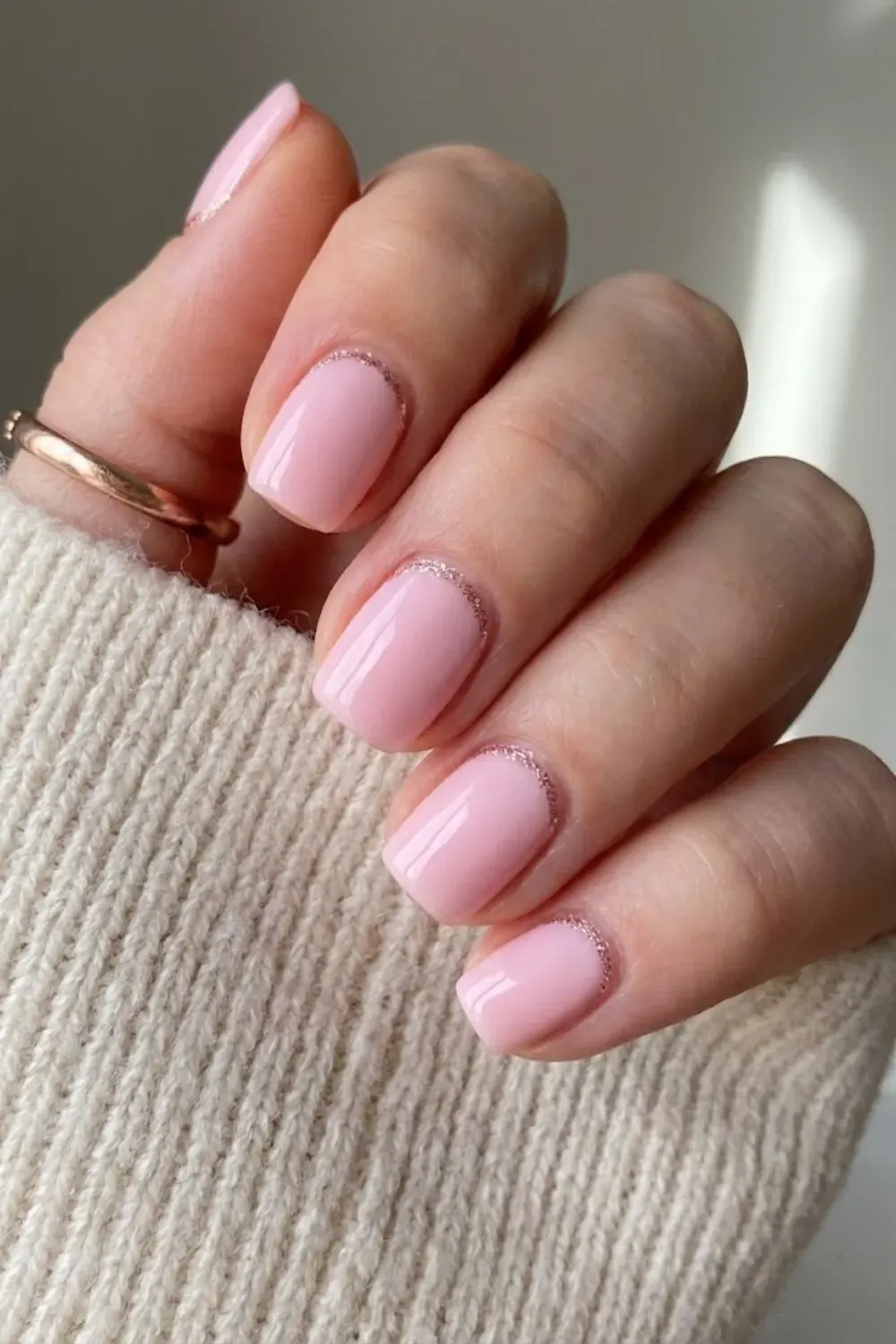 Pink with Rose Gold Cuticle Curve - Short square-oval pink nails detailed with a fine rose gold glitter curved line near the cuticle.