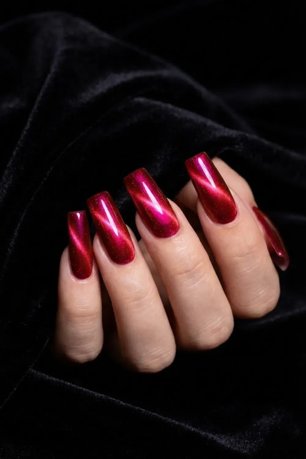 Red to pink multichrome cat eye nails with fiery magnetic shimmer on long square nails