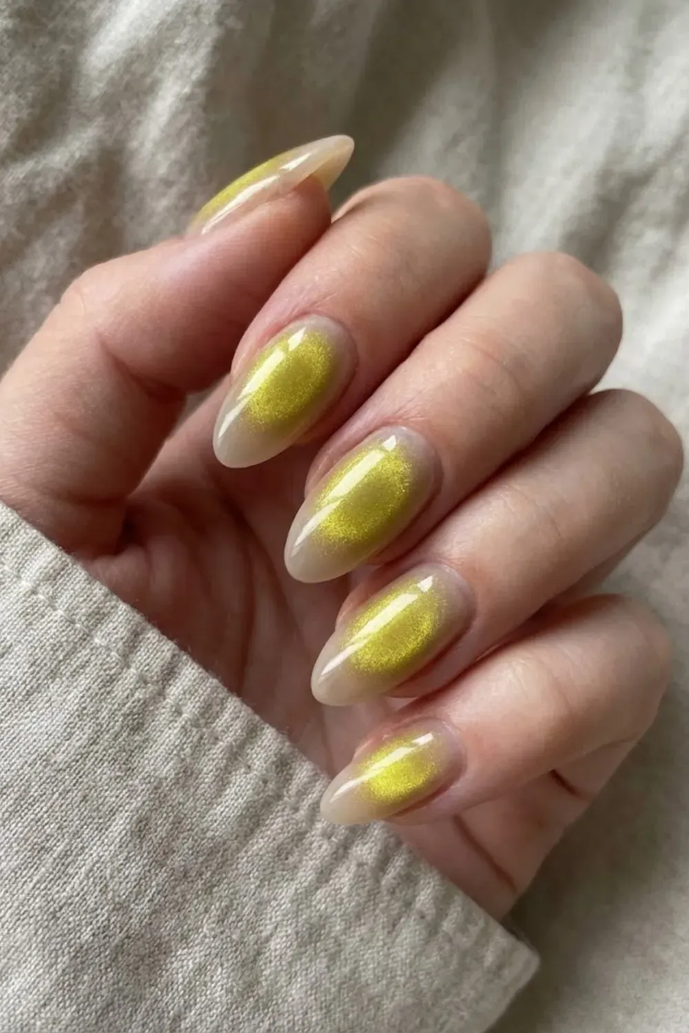 Golden aura cat eye nails with glowing center and sheer neutral edges