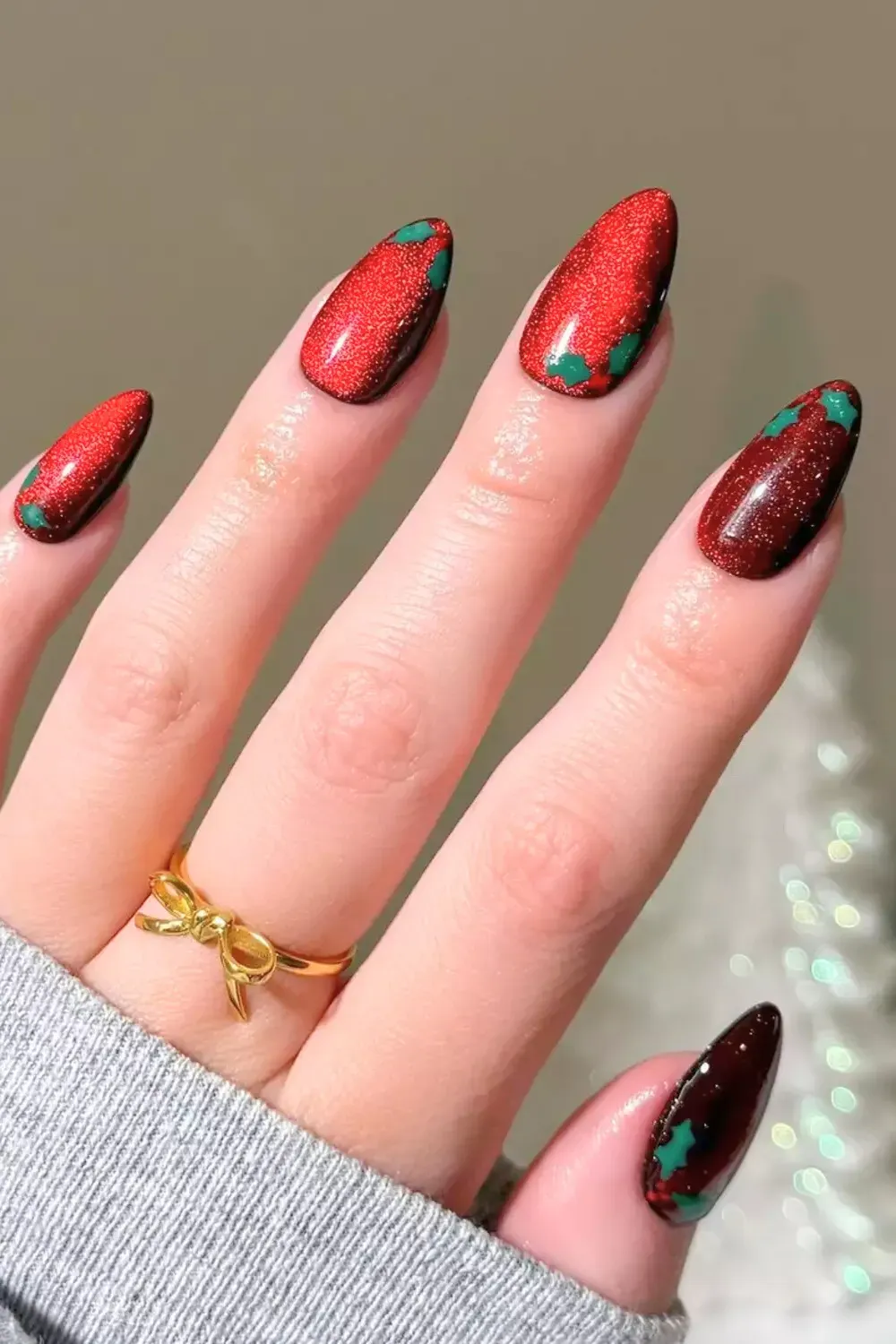 Red Velvet Cat-Eye with Holly Art - Red magnetic velvet nails with small green holly leaf accents.