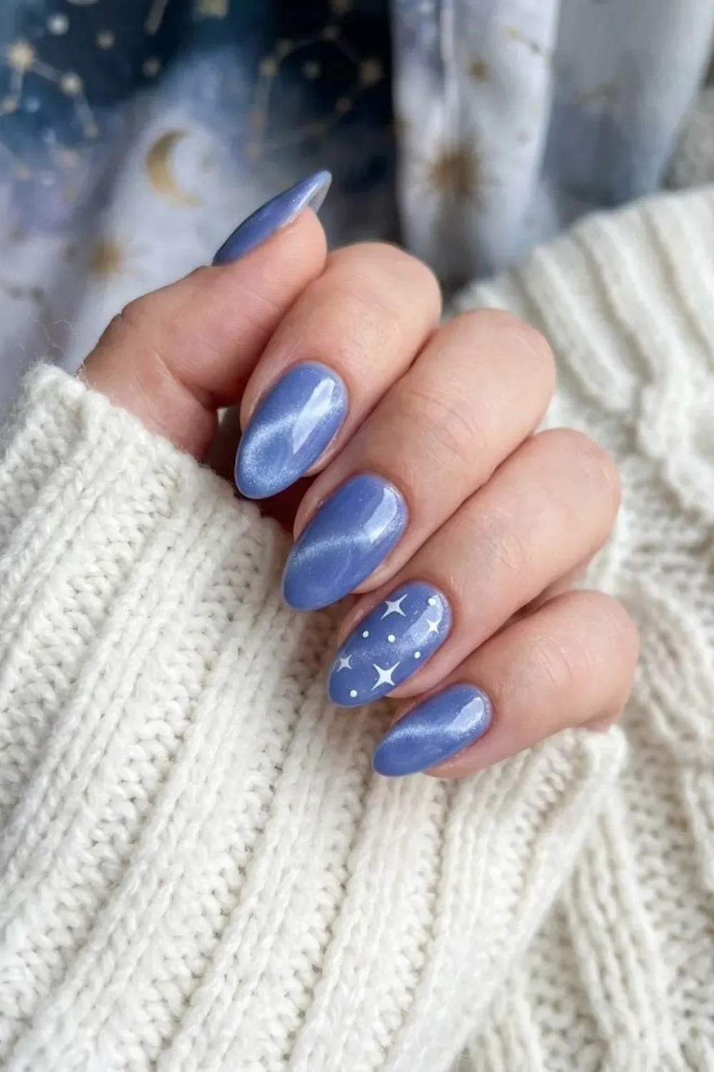 Periwinkle blue cat eye nails with celestial star nail art details
