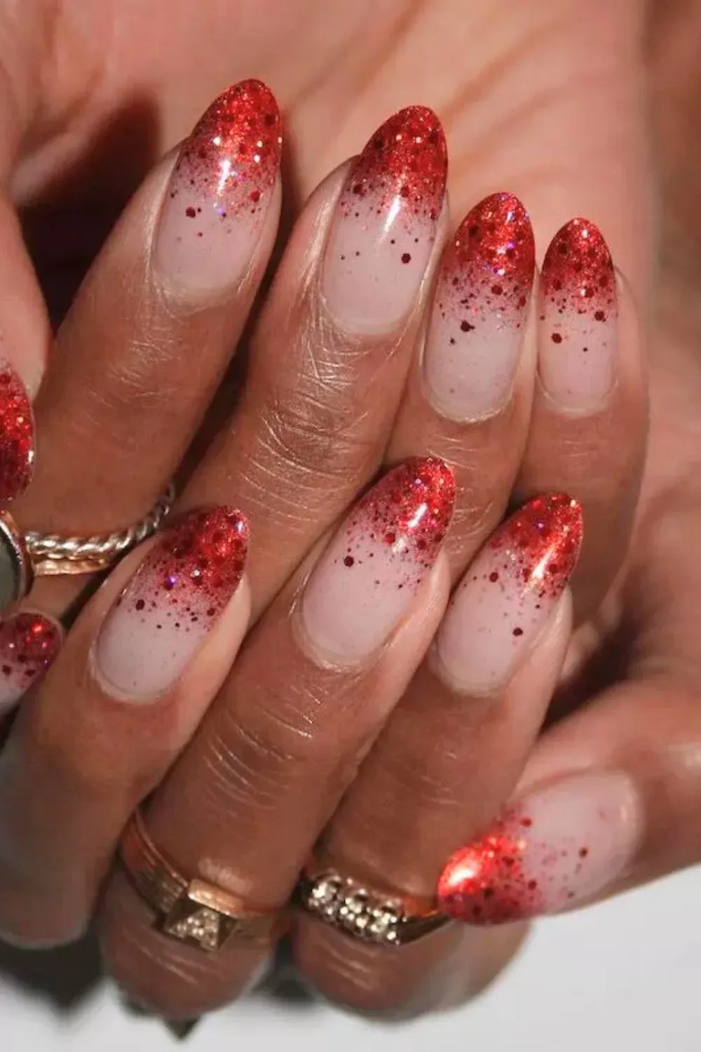 Red Glitter Gradient Ombre Nails - Nude nails fading into sparkly red glitter at the tips.