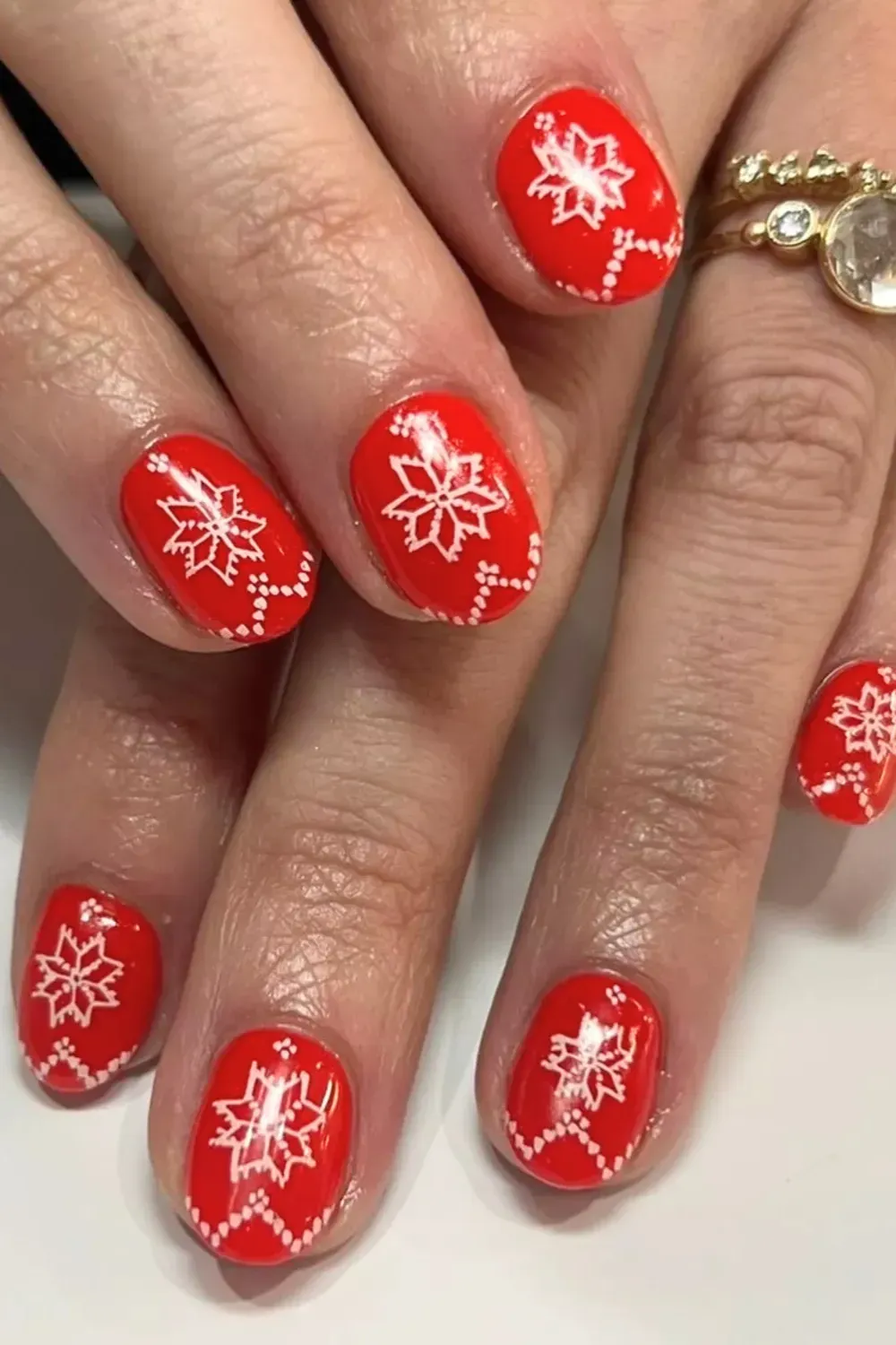 Red Nails with White Fair Isle Pattern - Bright red nails with white stamped sweater and snowflake patterns.