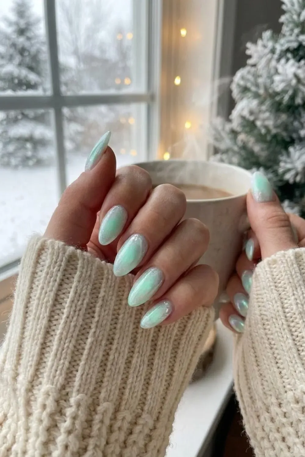 Icy Mint Chrome Nails – pearlescent mint green almond nails with frozen chrome effect