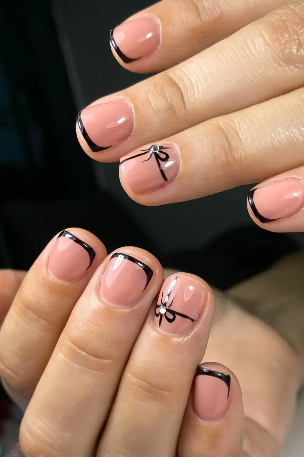 Coquette Black French with Bows	Nude nails with thin black french and black bow charm