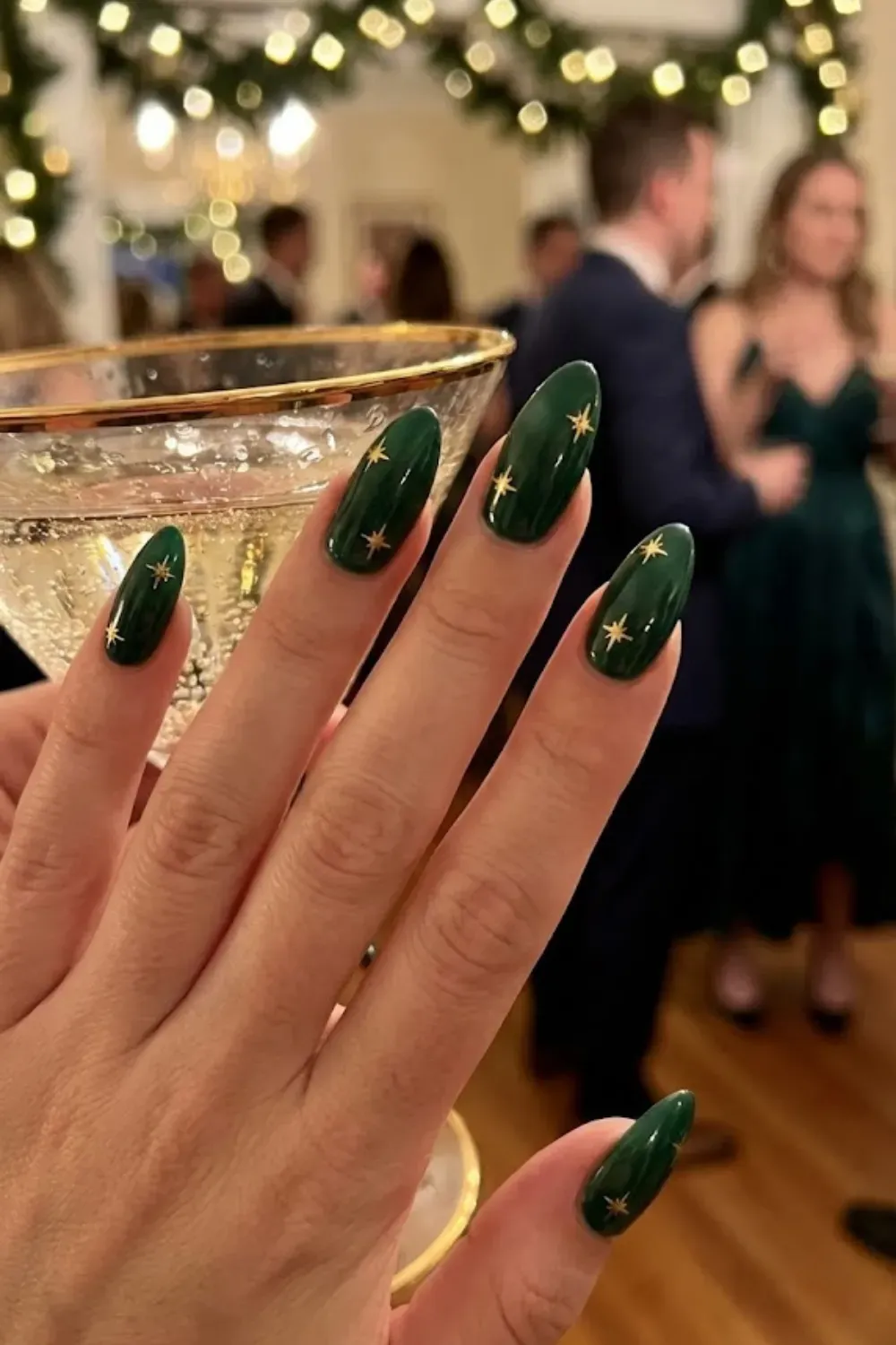 Emerald Green Nails with Gold Stars - Glossy deep emerald green nails featuring elegant hand-painted gold starbursts.