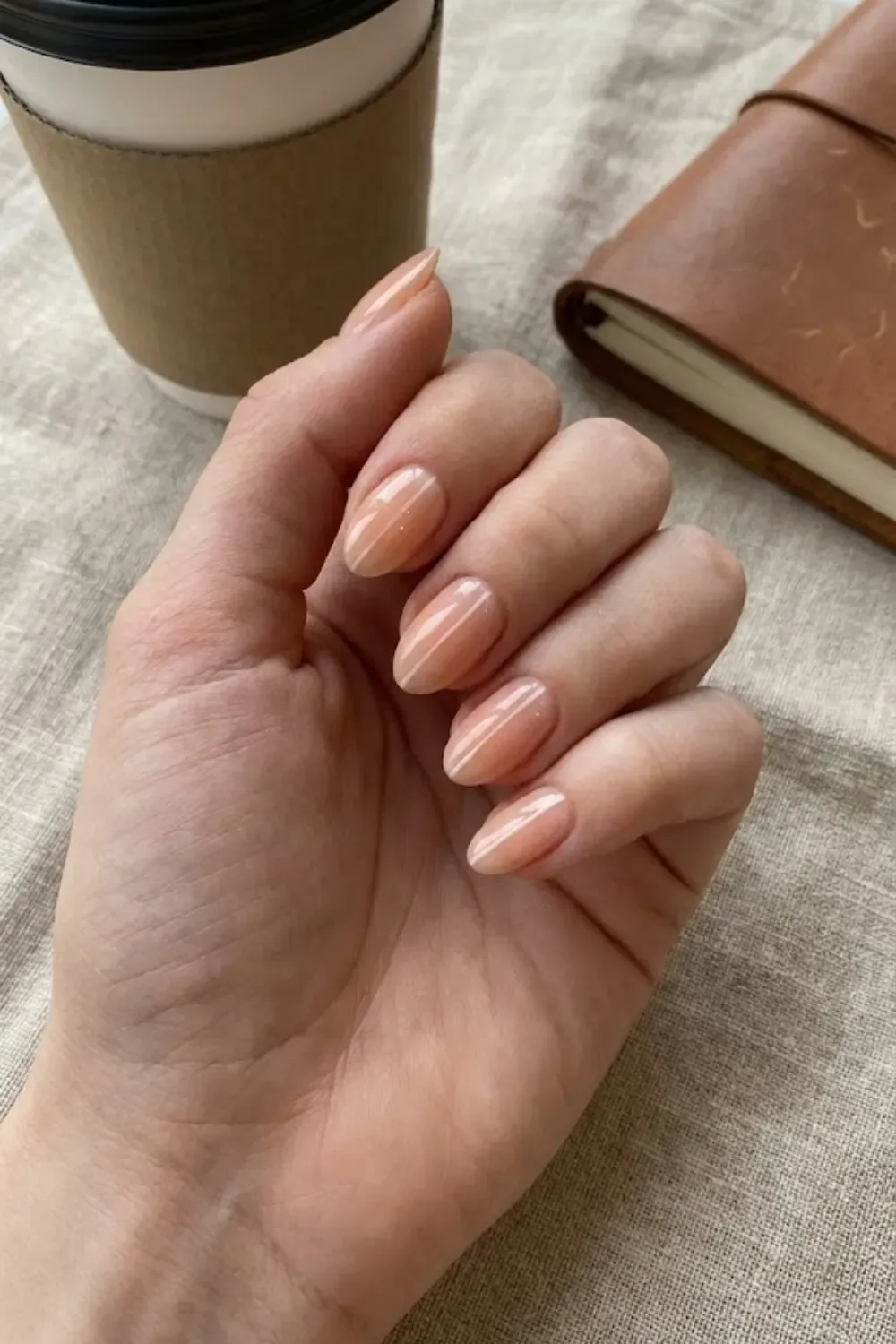 Peach Nude Vertical Line – Almond shaped sheer peach nails with a sleek white vertical line down the center.