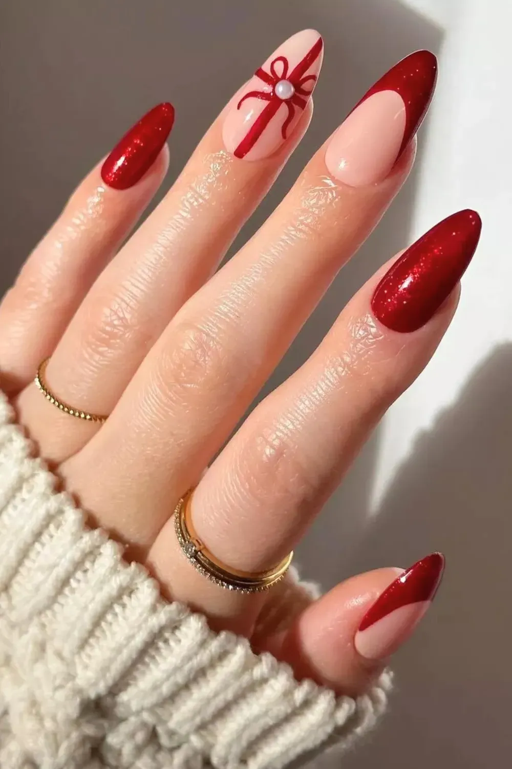 Red French with Ribbon and Pearl Detail - Red glitter french tips with one accent nail featuring a red ribbon and pearl.