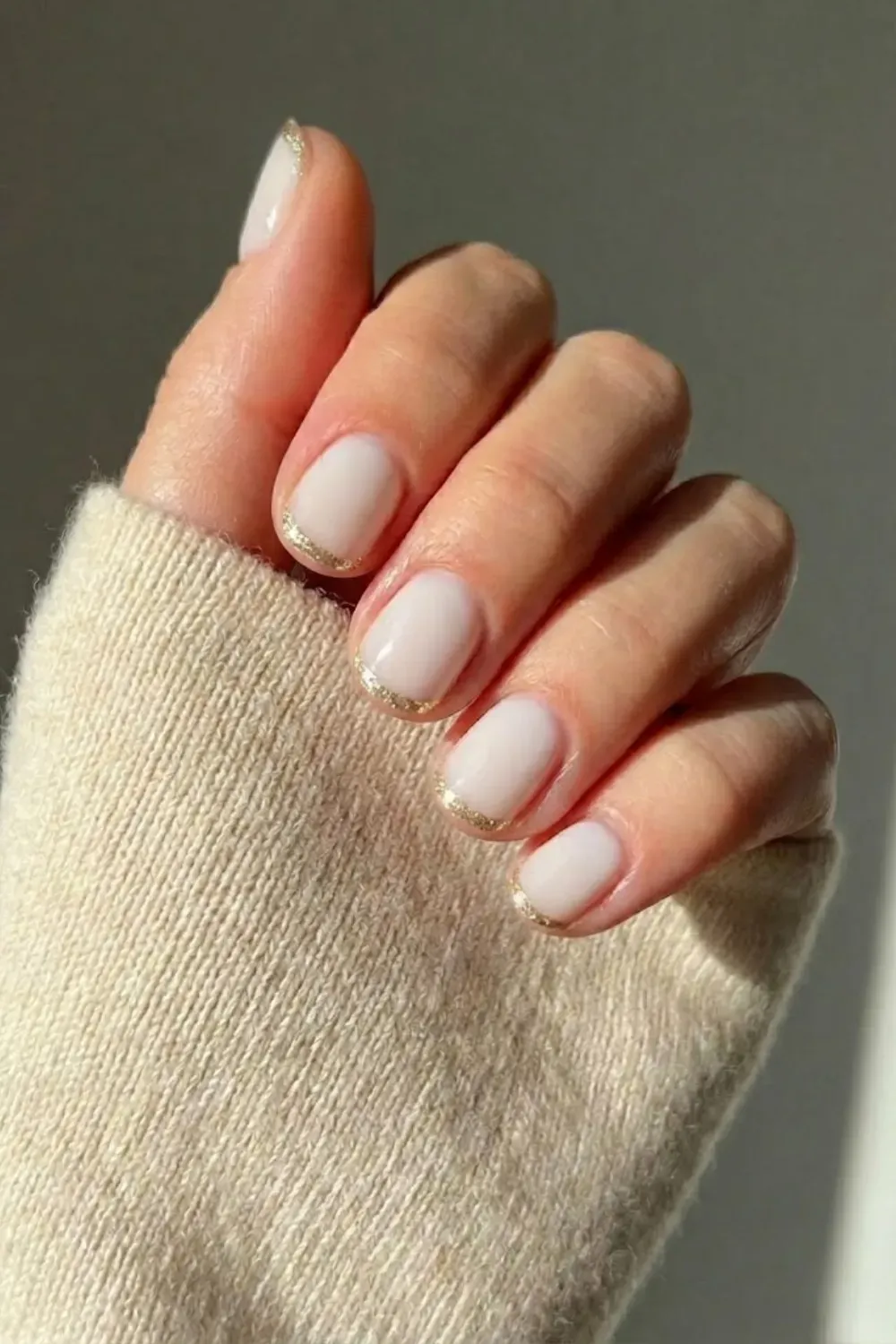 Short Milky White Gold French - Classic short oval nails with a glossy milky base and a precise gold metallic French tip