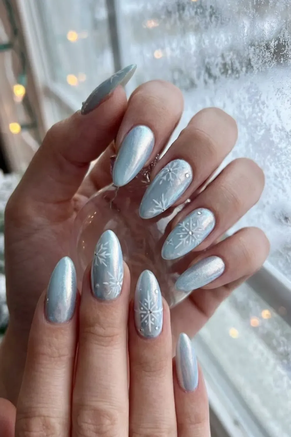 Icy Chrome with Dangling Snowflake - almond light blue chrome nails with dangling silver snowflake charm piercing