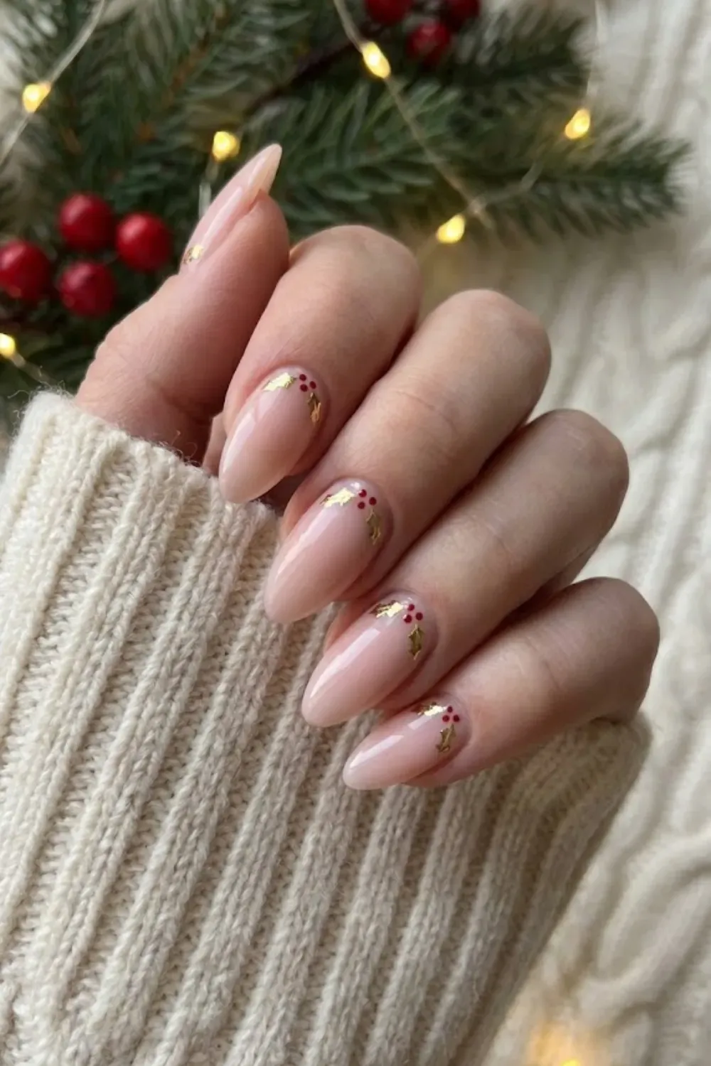 Nude Nails with Minimalist Holly Leaves - Natural almond nails featuring delicate and minimalist holly leaf and berry nail art.