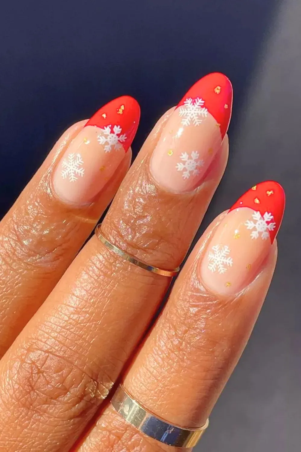 Red French Tips with White Snowflakes - Red french manicure overlaid with white snowflake stamps.
