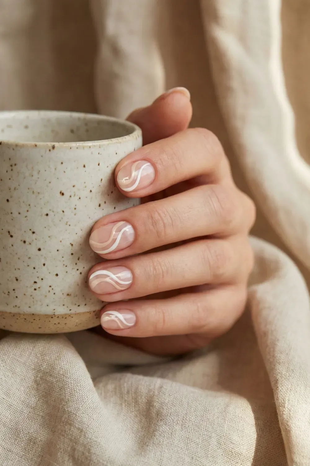 Abstract Beige & White Swirls - Short natural nails with negative space art featuring delicate white and beige abstract swirl lines.