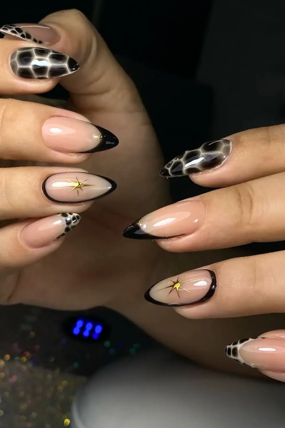 Tortoise Shell and Starburst	Almond nails with black french, tortoise print and starburst