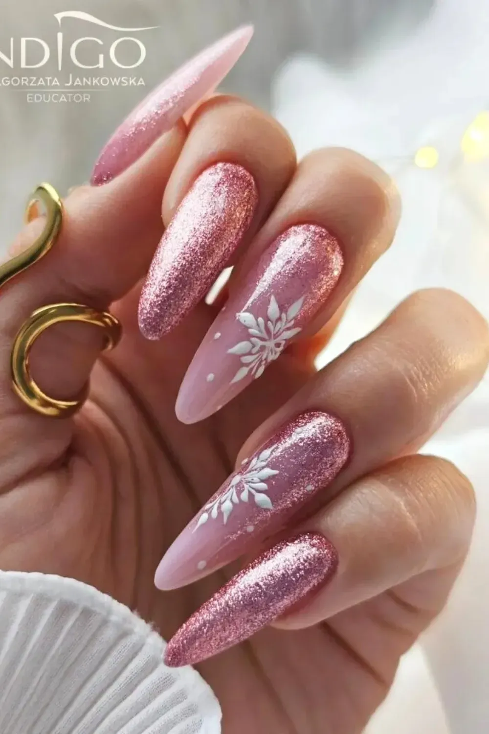 Dreamy Watercolor Snow - Almond nails with a watercolor pink background and delicate white snowflakes.