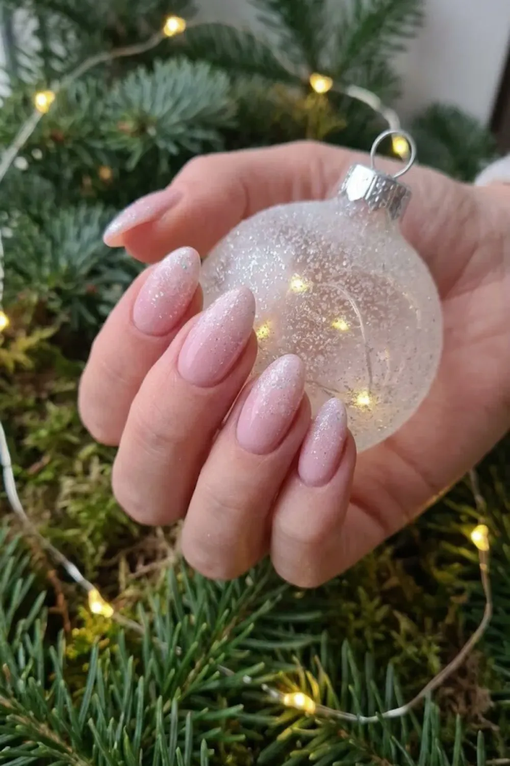 Light Pink Nails with Silver Foil and Stars - Soft pink almond nails adorned with scattered silver foil flakes and tiny twinkling stars.