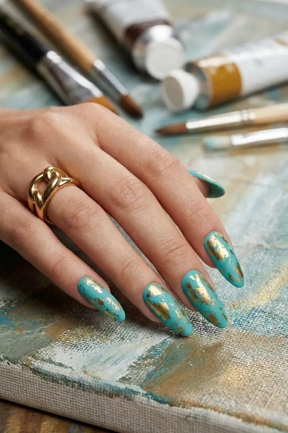 Turquoise nails with distressed gold cat eye foil nail art design