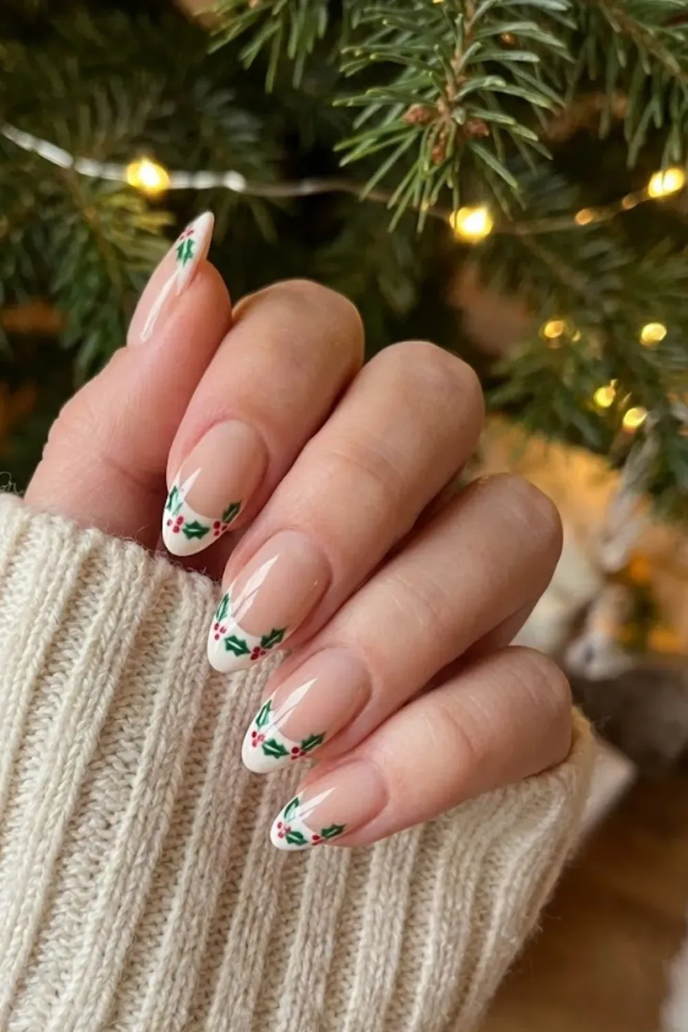 Mistletoe Garland Tips — almond nails with French tips formed by hand-painted holly leaves and berries.