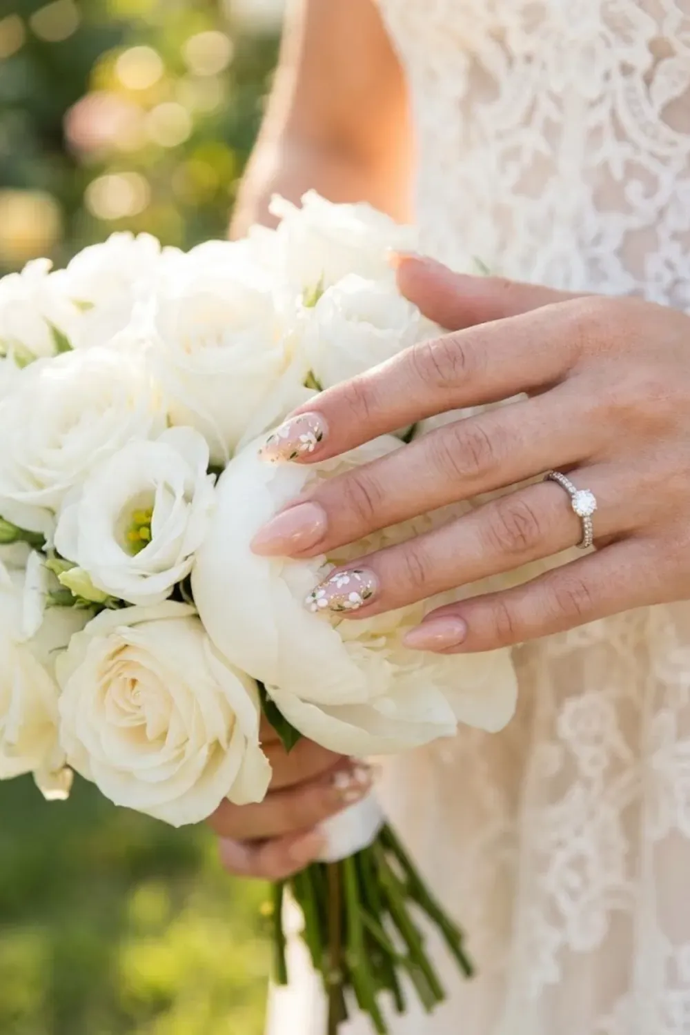 Dainty White Floral & Greenery - Hands near wildflowers; small white flowers painted on nails.