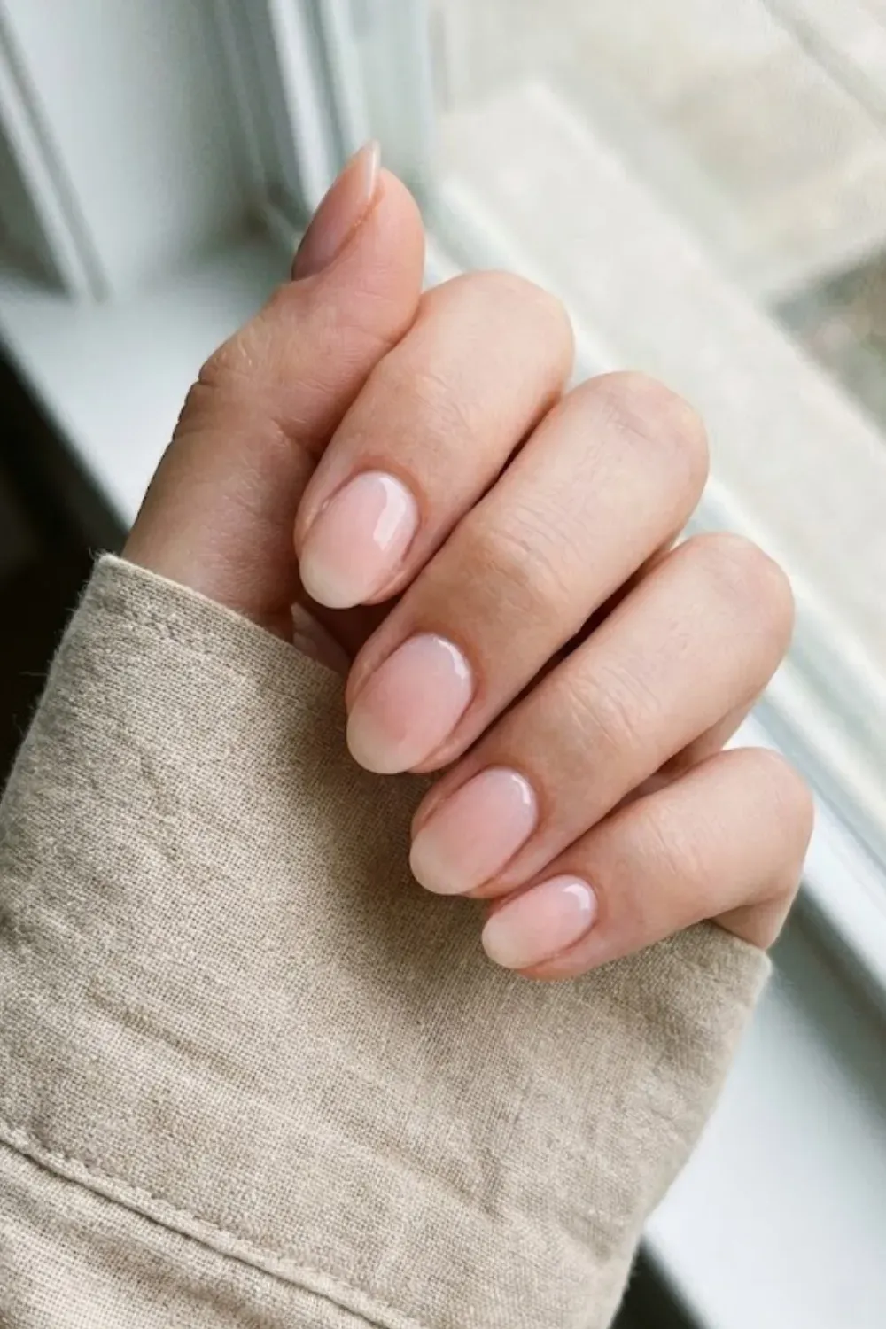 Clean Sheer Pink Natural – Short oval nails with a glossy sheer pink "your nails but better" polish.