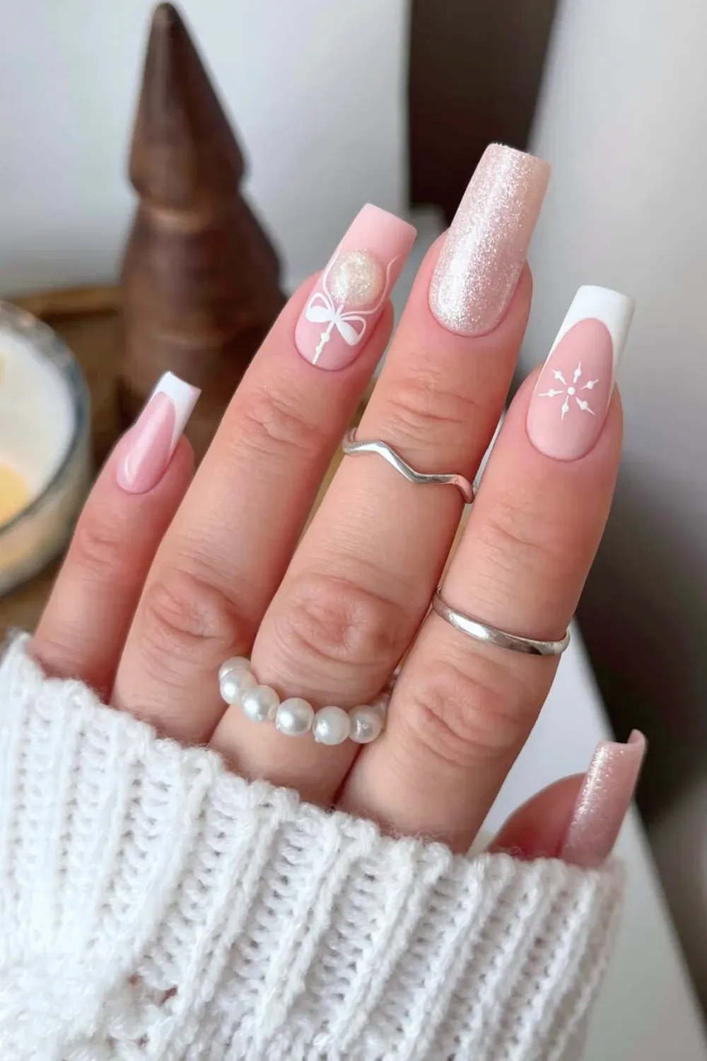 Coquette Bow & Snowflake - Coffin shaped pink french tip nails with 3D white bow and snowflake art.