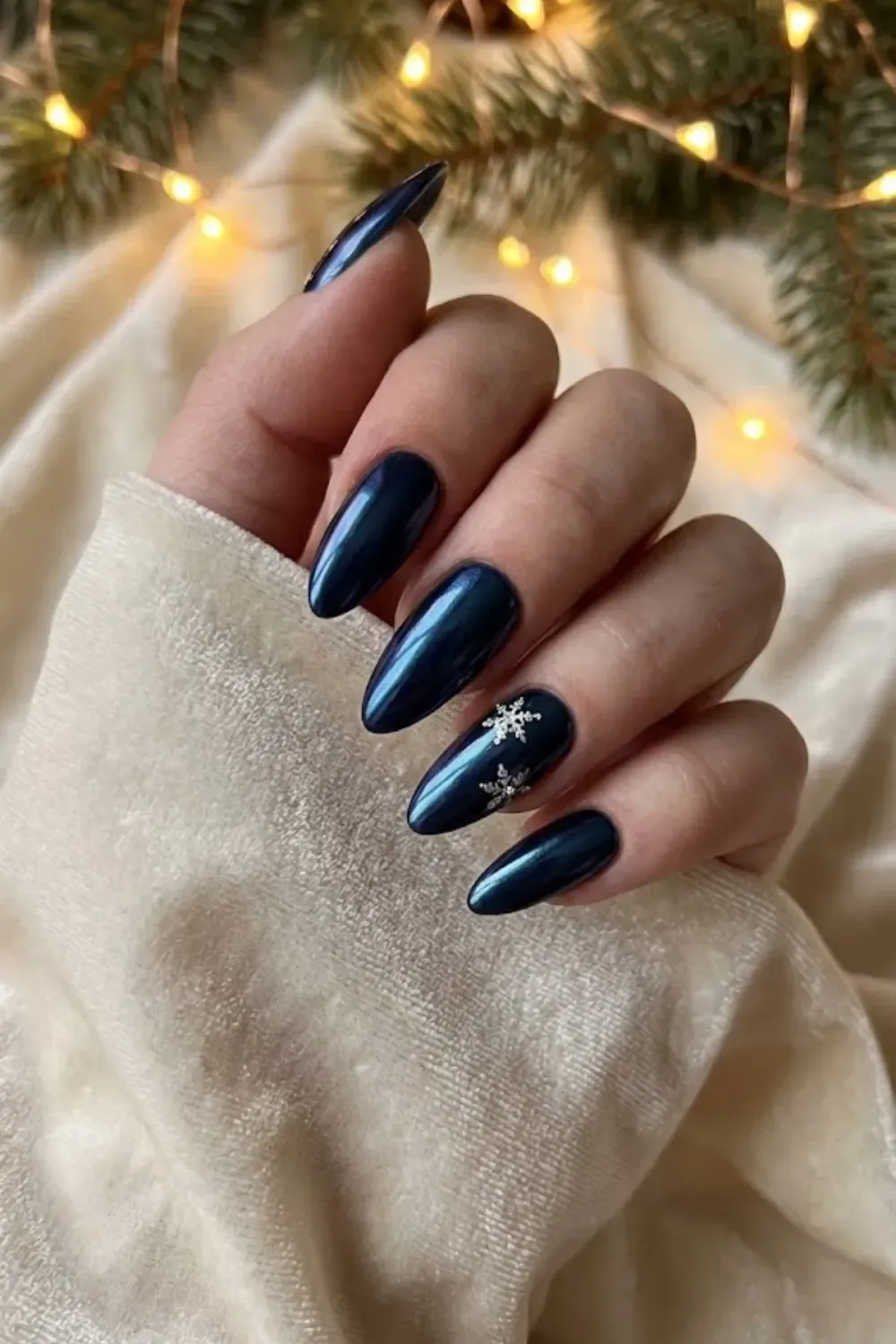 Midnight Blue Chrome with Snowflakes - almond metallic dark blue chrome nails with white snowflake nail art