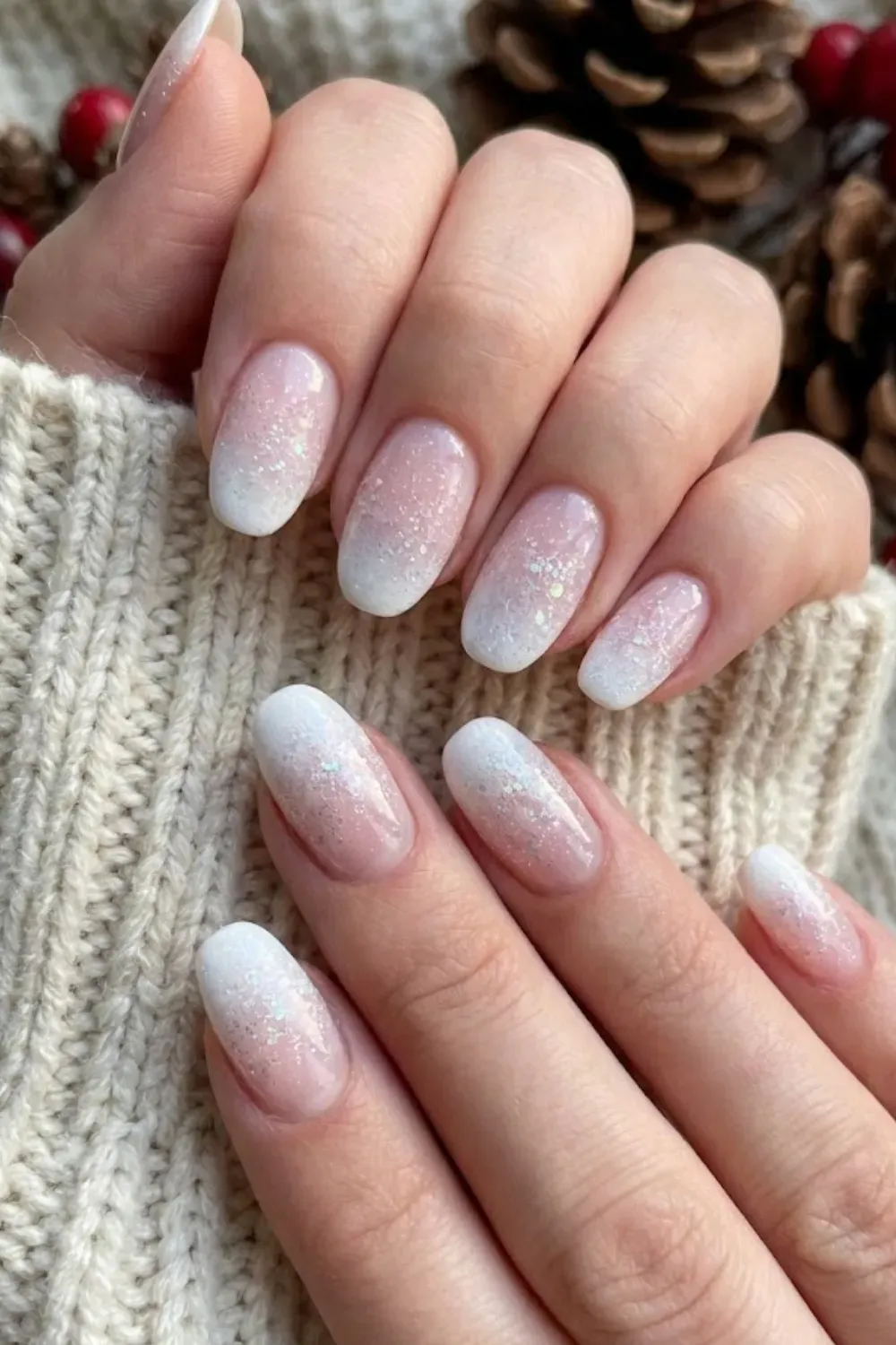 Frosty White Glitter Ombre — long oval nails with white tips fading into a frosty silver glitter gradient.
