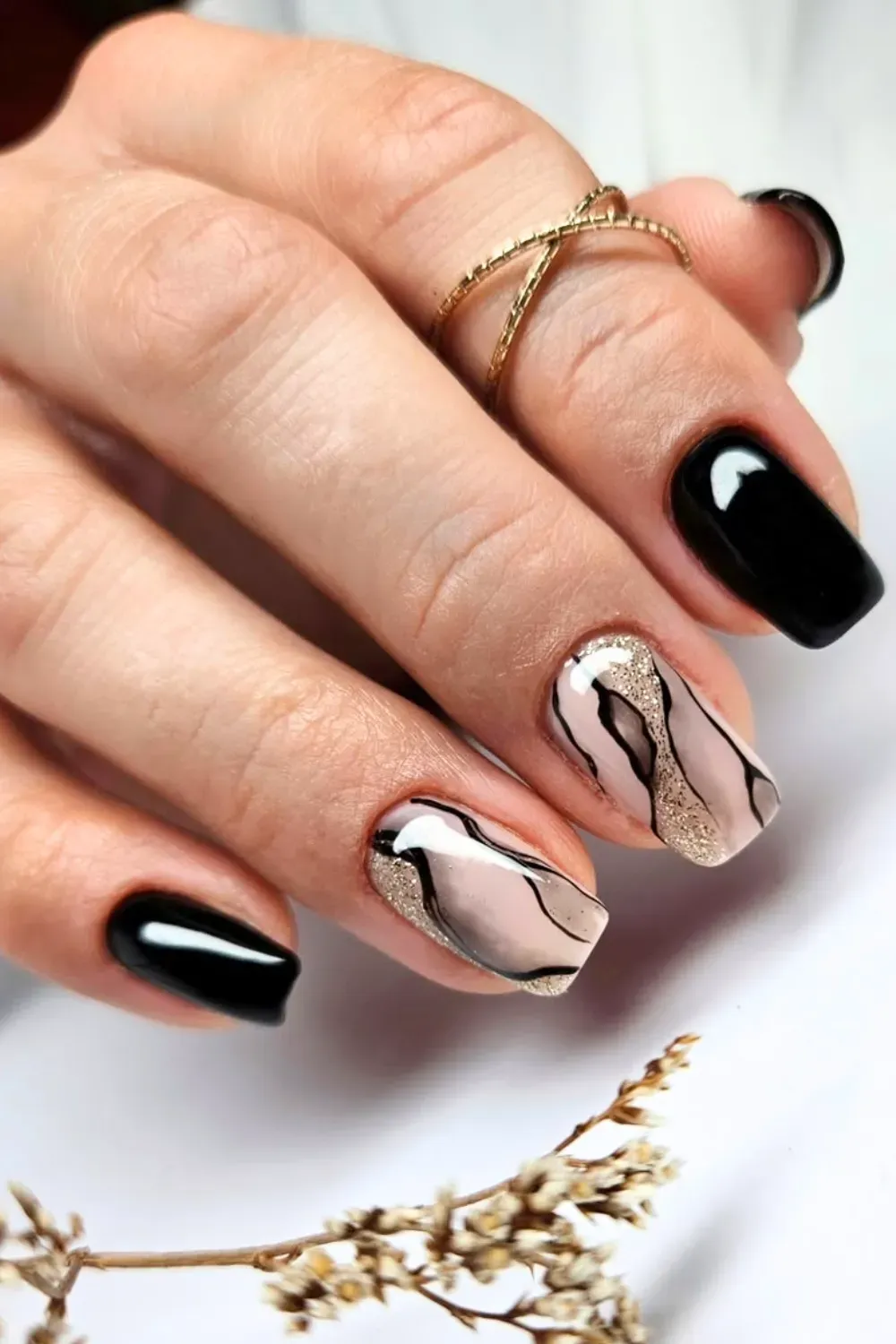 Black and Glitter Swirls	Black nails with nude accent nail and black glitter swirls