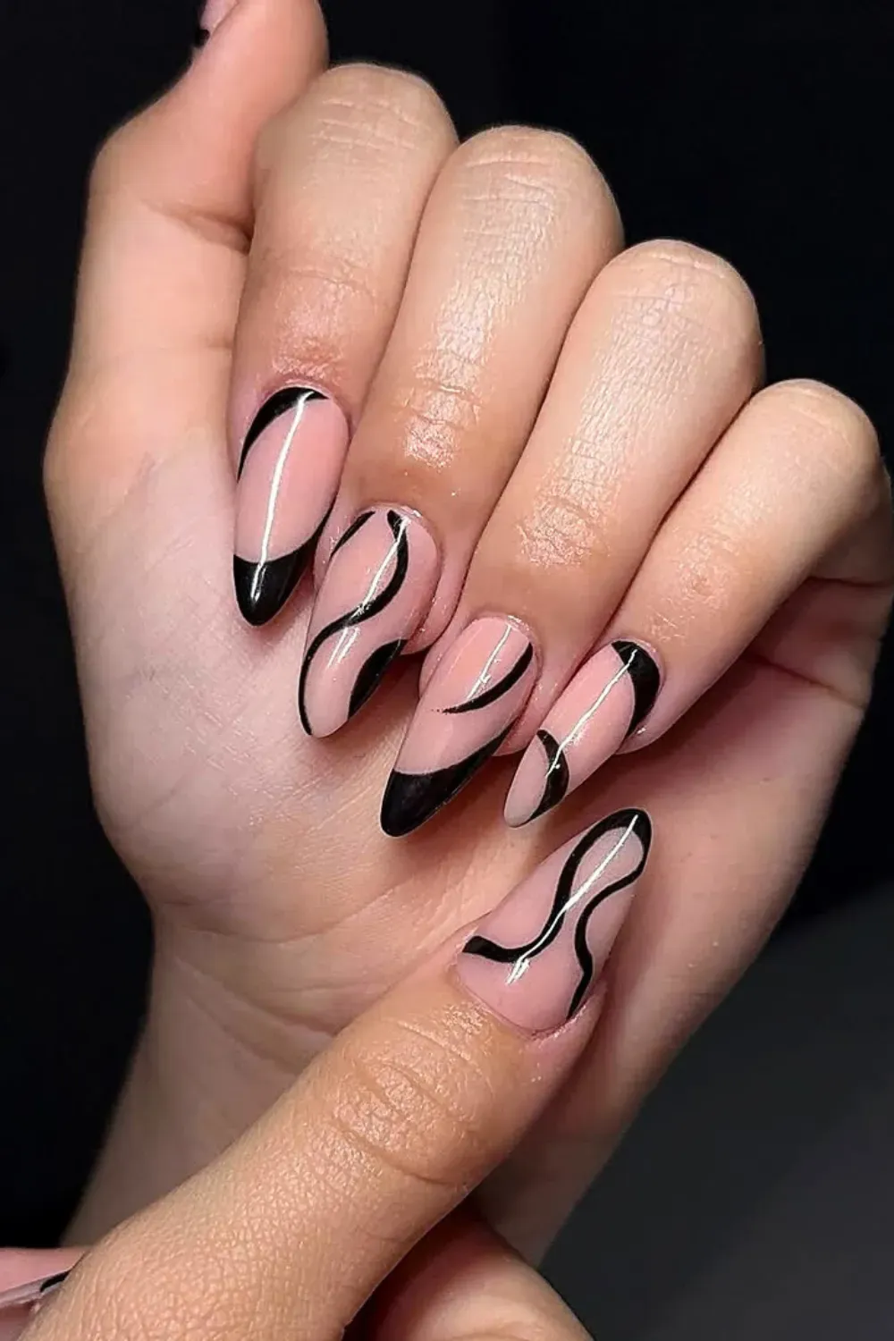 Negative Space Abstract Swirls	Nude almond nails with black abstract swirl lines