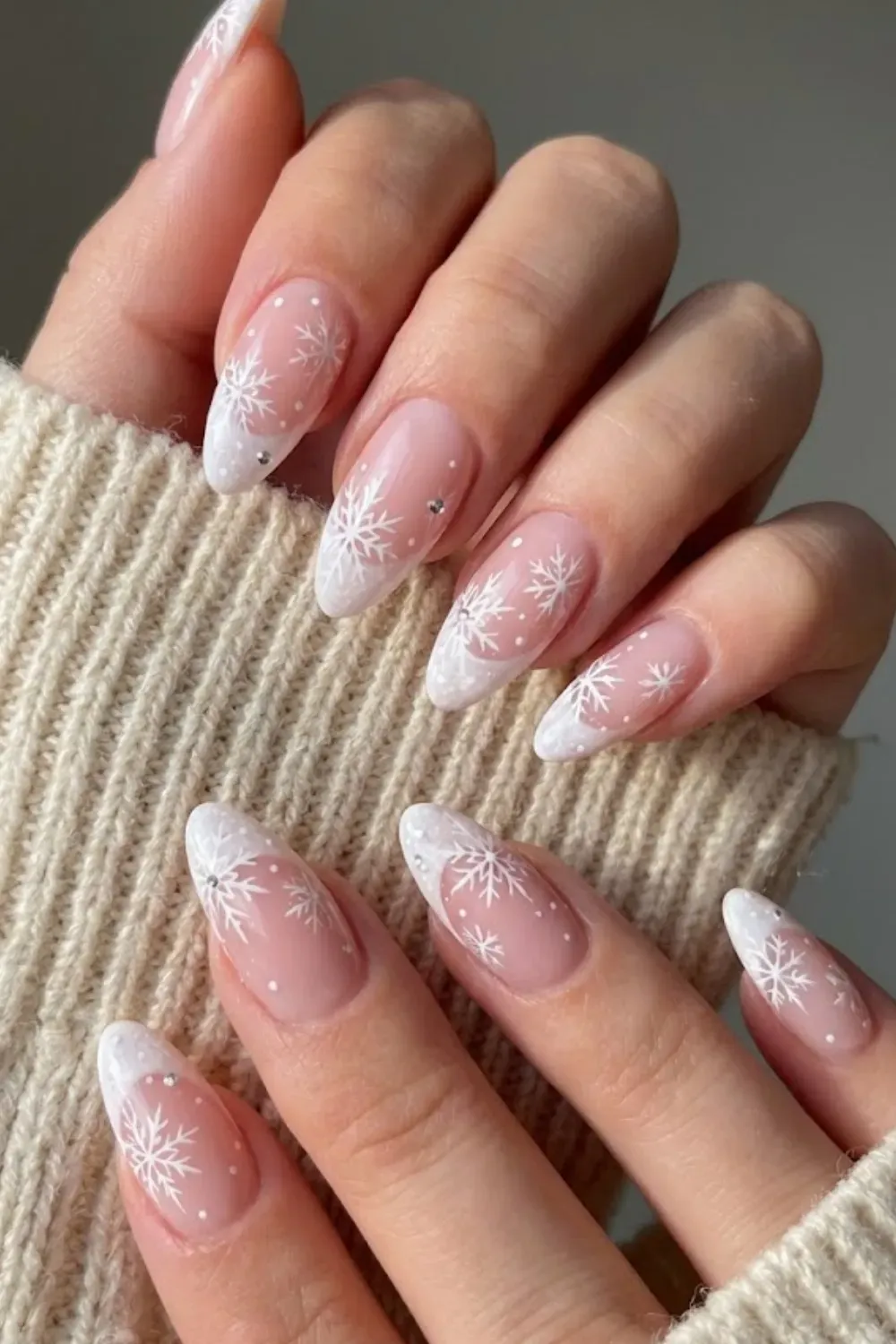 Nude Base Snowflake Nails — white French tips with delicate snowflakes and silver dots on a sheer base.