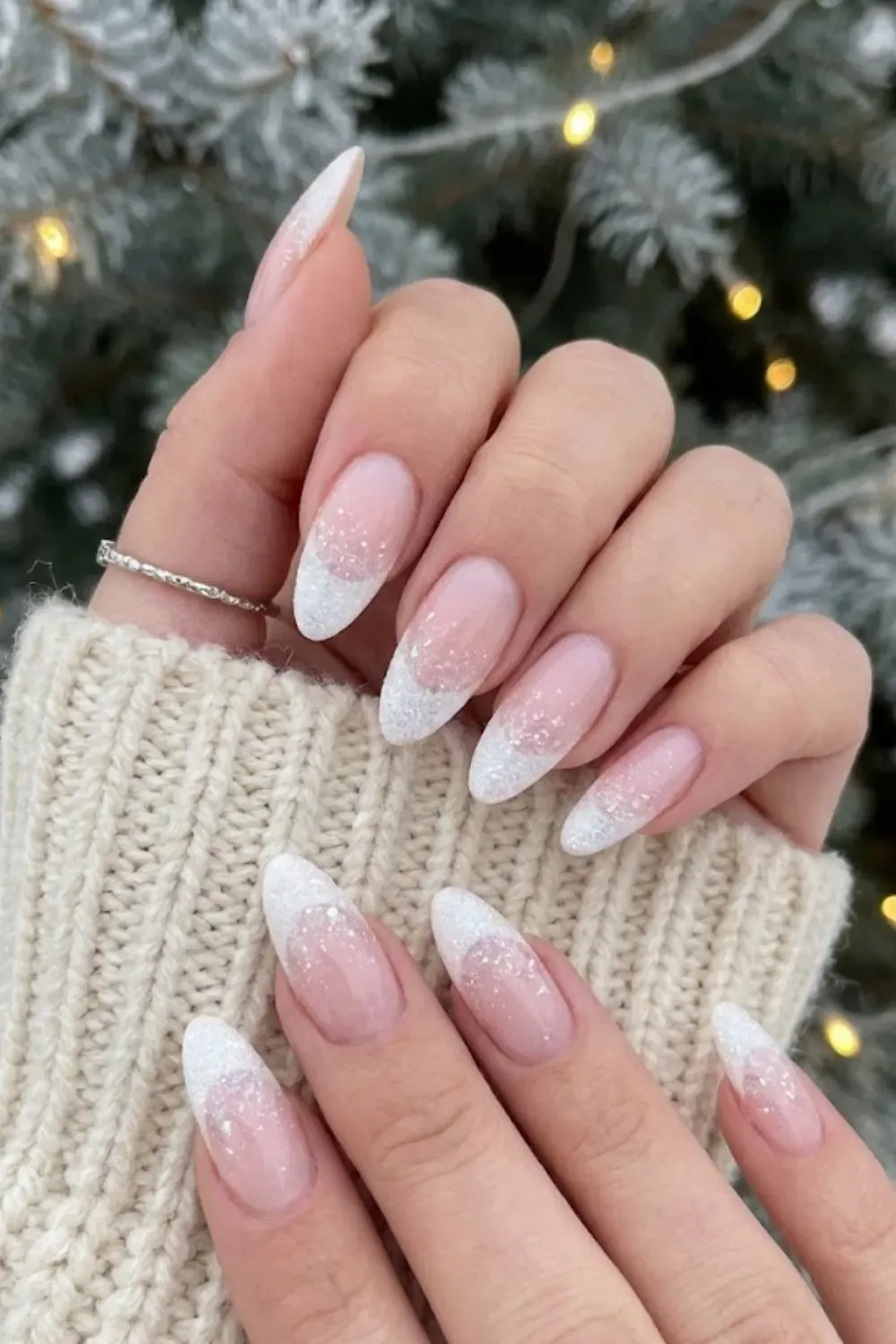 Pink White Glitter Fade — oval nails with a soft white tip gradient covered in iridescent pink glitter.