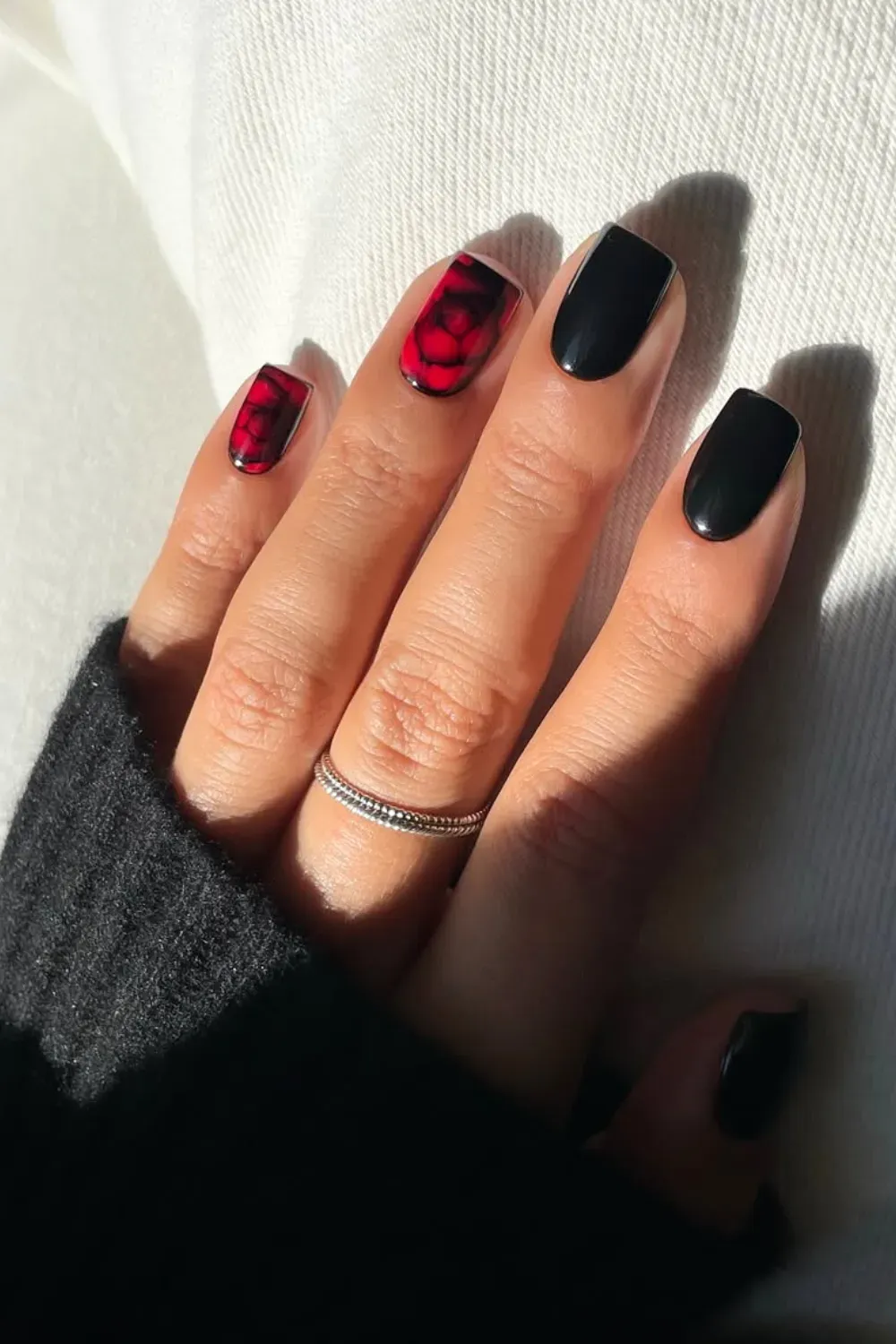 Bold Red and Black Marble	Glossy black nails with red and black marble accent