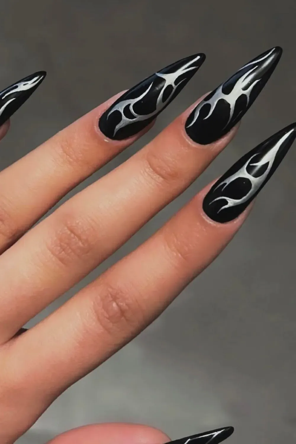 Tribal Silver Chrome Flames	Stiletto nails with black base and silver tribal flame art