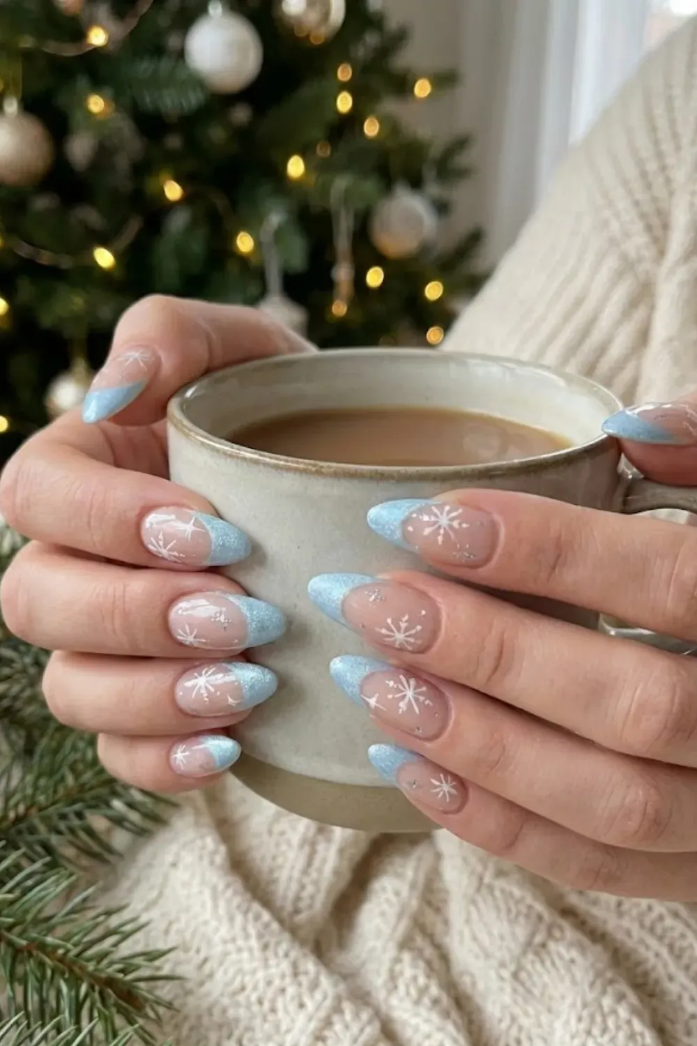 Icy Blue Snowflake Nails — almond nails with blue glitter French tips and delicate white snowflakes.