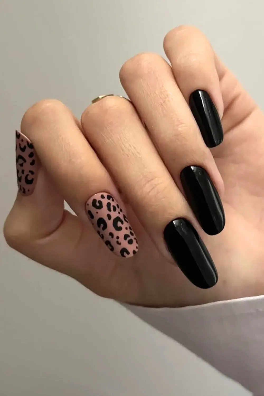 Chic Matte Leopard Print	Glossy black nails with matte nude leopard print accent