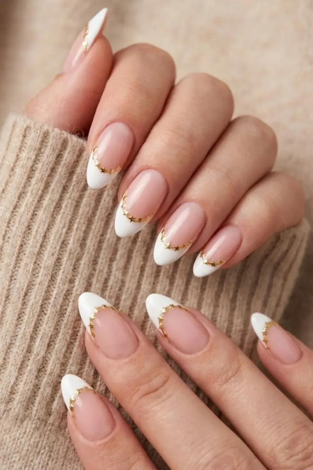 Gold Star Cuff White Tips — almond nails with white French tips outlined by a curve of gold stars.