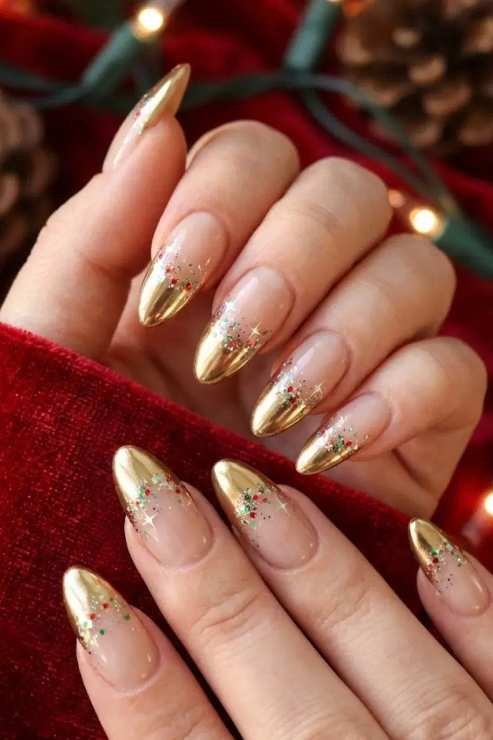 Gold Chrome Confetti Nails — oval nails with gold chrome tips and scattered holiday color glitter confetti.