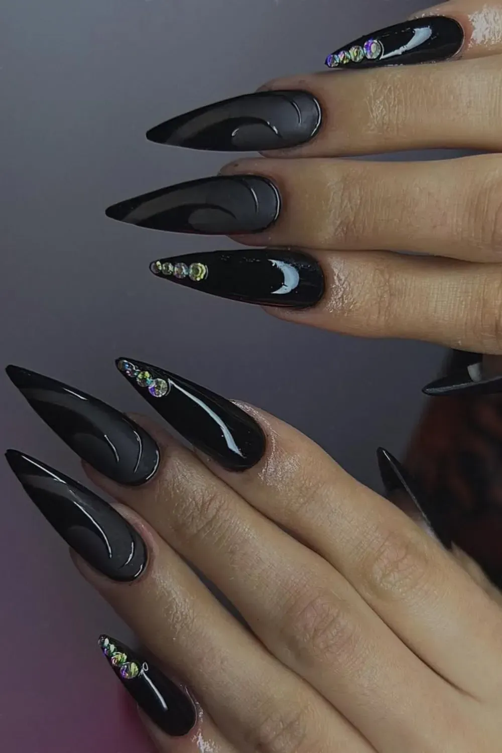 Matte Black Swirls with Gems	Stiletto matte black nails with glossy swirls and rhinestones