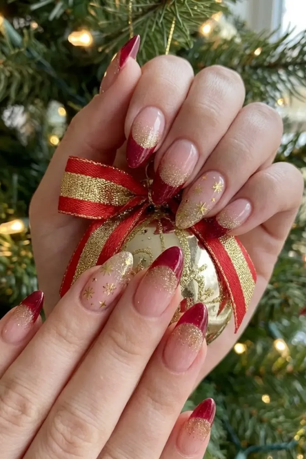 Red Gold Glitter Gradient — oval nails with deep red tips blended with a sparkling gold glitter gradient