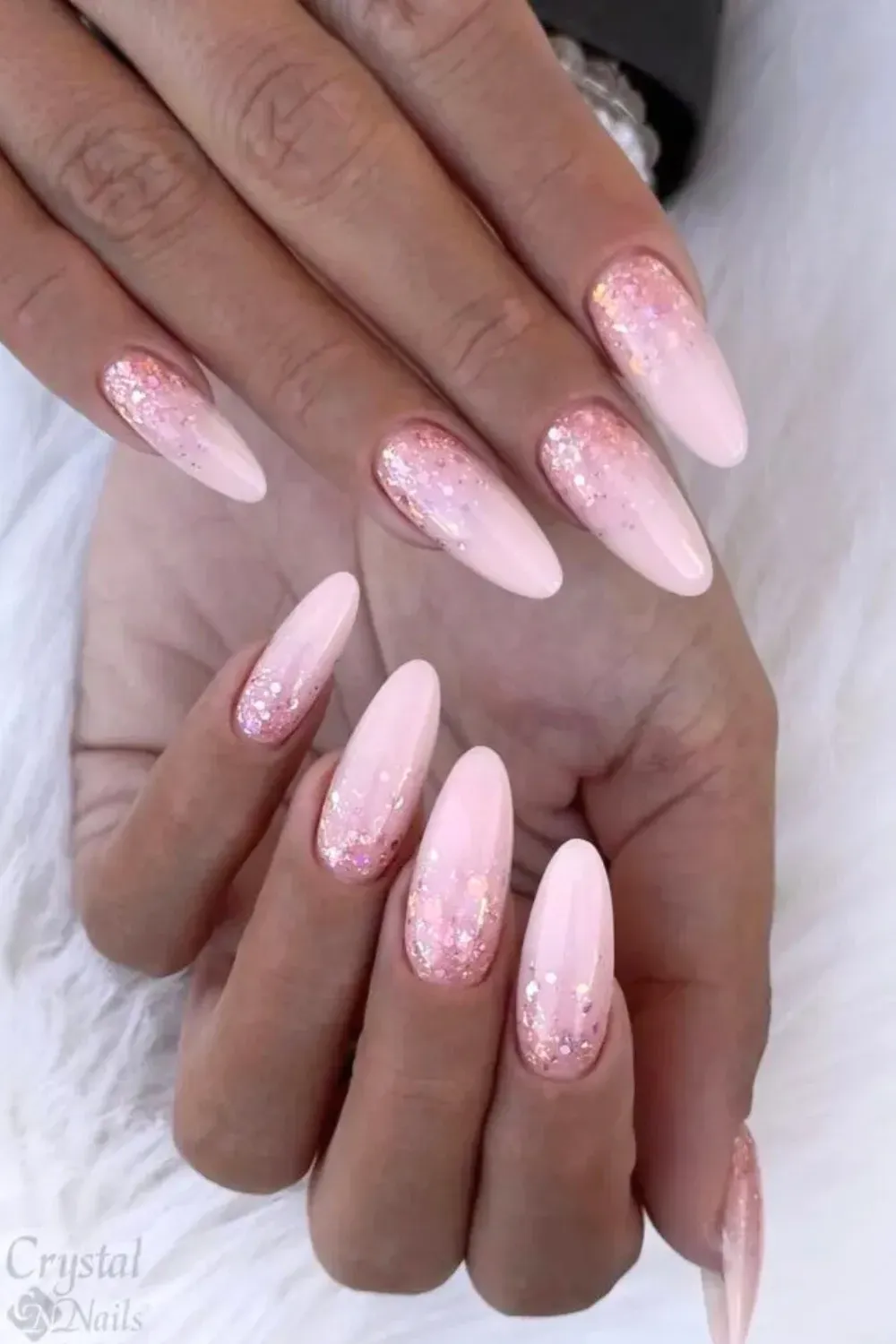 Rose Gold Glitter Ombre - Almond shaped nails with a gradient fade from pink to rose gold glitter.