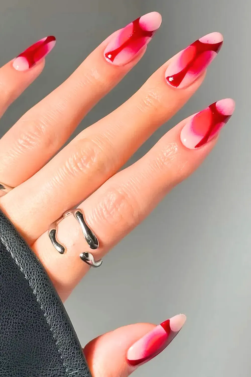 Abstract Red Watercolor Nail Art - Almond nails with an abstract, bleeding red watercolor design at the tips.